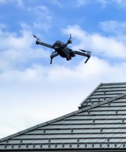 Drone inspecting house roof